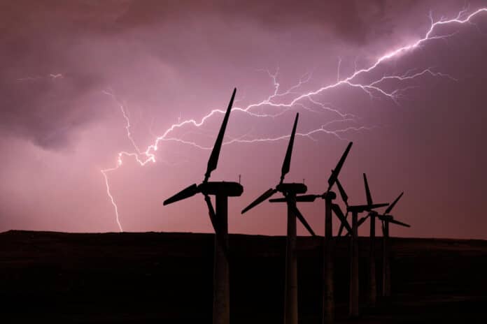 Silhouette of wind turbines on the background of a stormy sky